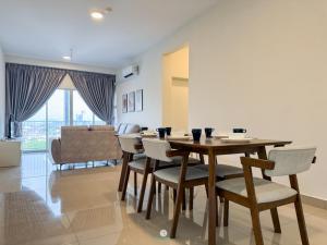 a living room with a wooden table and chairs at Cozy 4B2B for 8 pax - 15 min to Lotus's Mall Kajang in Kampong Paya