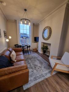 a living room with a couch and a table at The Auction House in Belfast