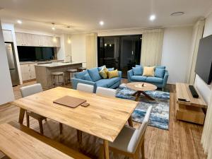 a living room with a dining table and a kitchen at Nelum managed by Sahas Homes in Dunsborough