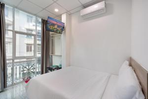 Postel nebo postele na pokoji v ubytování Hoàng Quỳnh Hotel