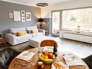 a living room with a table with a bowl of fruit on it at Exklusive Wohnung Mit Ahrblick 2 in Bad Neuenahr-Ahrweiler