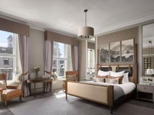 a bedroom with a bed and a desk and a chair at InterContinental Edinburgh The George by IHG in Edinburgh