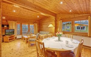 a dining room with a table and chairs and a television at 2 Bedroom Nice Home In Masserberg in Masserberg
