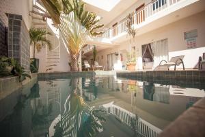a swimming pool in a house with plants in it at Pousada Hotel Boutique Ventanas in Carolina +15 photos