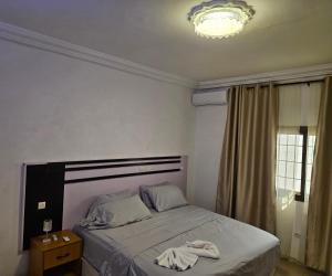 a bedroom with a bed with a robe on it at Villa Blue Serenity in Lomé