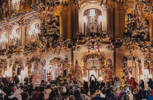 a crowd of people in a building with christmas decorations at Art Boutique Residence in Bucharest