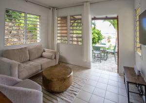 a living room with a couch and a coffee table at Cozy Cottage 1 bedroom with Stunning Views in Simpson Bay