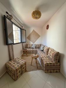 a living room with a couch and a table at L'étoile de taghazout in Taghazout