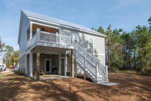 a house with a staircase on the side of it at Island Escape Relax and Unwind in Pawleys Island in Pawleys Island