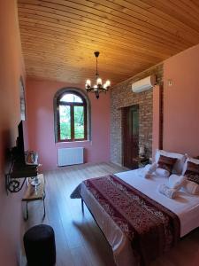 a bedroom with a large bed and a window at Château Fort de Manavi, Boutique Hotel in Manavi