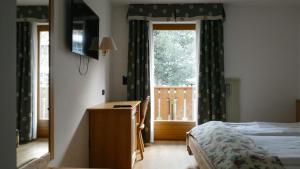 Postel nebo postele na pokoji v ubytování Hotel Malga Passerella