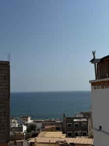 a view of a city with the ocean in the background at L'étoile de taghazout in Taghazout +7 photos