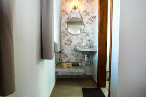 a bathroom with a sink and a mirror at Pousada Lapinha Da Serra 1 - Chalés Independentes e Privativos - Liberdade e Conforto na natureza in Santana do Riacho