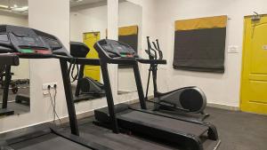 a gym with several tread machines in a room at Hotel I-stay Hitec in Hyderabad