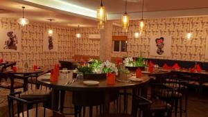 a restaurant with tables and chairs in a room at Hotel I-stay Hitec in Hyderabad