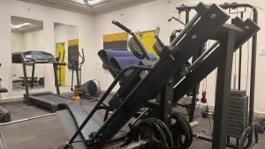 a room with a gym with cardio equipment in it at Hotel I-stay Hitec in Hyderabad