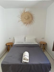 a bedroom with a bed with a towel on it at L'étoile de taghazout in Taghazout
