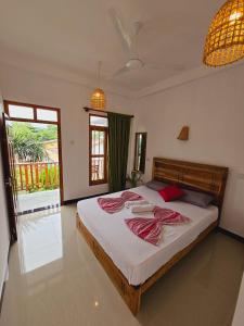 A bed or beds in a room at Sun Rest Mirissa