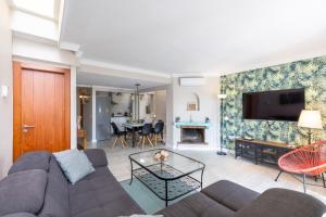a living room with a couch and a table at Charming house next to the sea in Benalmádena