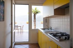 a kitchen with a sink and a view of the ocean at Casa Leonardo by Villa Porta Collection in Luino