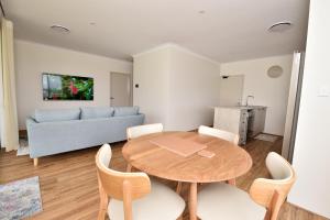 a living room with a table and a couch at Olu managed by Sahas Homes in Dunsborough
