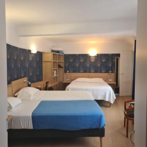 a hotel room with two beds in a room at Hotel La Louisiane in Paris