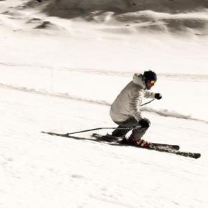 a person is skiing down a snow covered slope at Albergo Pontafel in Pontebba