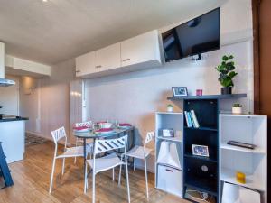 a kitchen and dining room with a table and chairs at Studio Soyouz Vanguard-104 by Interhome in Le Corbier +33 photos