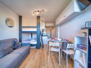 a living room with a couch and a bunk bed at Studio Soyouz Vanguard-104 by Interhome in Le Corbier