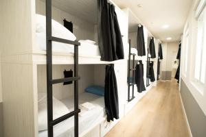 a walk in closet with white bunk beds at Adventure Hostel Madrid in Madrid
