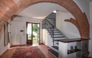 an archway in a hallway with a staircase in a house at Cozy Home In Fauglia With Wifi in Fauglia