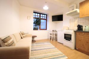 a living room with a couch and a kitchen at 1 bed Cheshire St London City Brick Lane Ideal for Family of 3 in London
