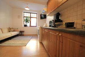 a kitchen with a counter top and a living room at 1 bed Cheshire St London City Brick Lane Ideal for Family of 3 in London