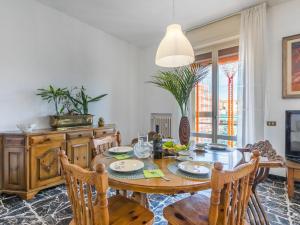 a dining room with a wooden table and chairs at Apartment Artista by Interhome in Cecina
