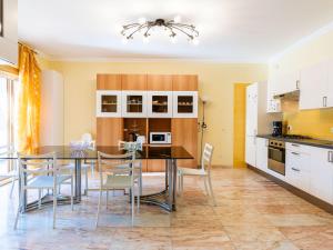 a kitchen and dining room with a table and chairs at Apartment le Mimose by Interhome in Taggia