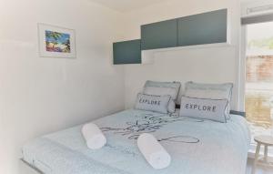 a white bedroom with a bed with two pillows at House Boat Statia in Maastricht