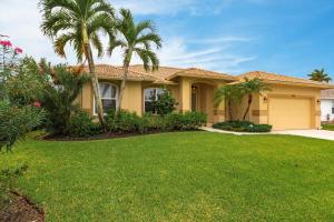 a house with palm trees in a yard at Marco Home - 3BR - Pet Friendly - Pool & Lanai in Marco Island