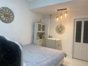 a bedroom with a bed and a clock on the wall at Lucky Home Pool Villa Chiang Mai in Chiang Mai