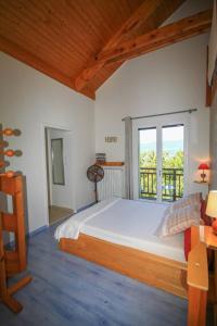 a bedroom with a large bed and a window at L'ermitage in Chambéry