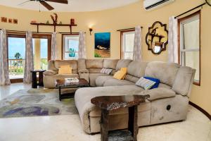 a living room with a couch and a table at Residences at Barrier Reef 3B Oceanview 2 BR by Stay Floreo in San Pedro