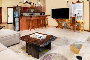 a living room with a coffee table and a kitchen at Residences at Barrier Reef 3B Oceanview 2 BR by Stay Floreo in San Pedro +64 photos