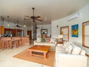 a living room with a couch and a table at Residences at Barrier Reef 8B Oceanview 2 BR by Stay Floreo in San Pedro +56 photos