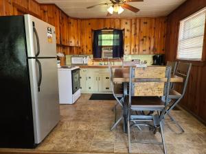 a kitchen with a refrigerator and a table and chairs at The White Stag in Hillsboro