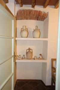 a room with shelves with vases on them at RESIDENZA Aida Luxury in Pistoia
