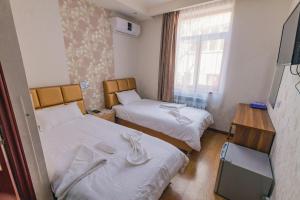 Postel nebo postele na pokoji v ubytování Hotel Garden House