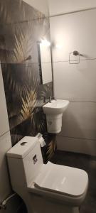 a bathroom with a toilet and a sink at Emmanuals beach house in Alleppey +44 photos