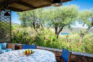 a table and chairs with a bowl of fruit on it at Caletta Nest 88 in Porto Rotondo +41 photos