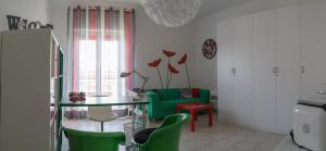 a living room with green chairs and a glass table at My Room in Trani in Trani