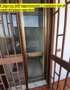 an open glass door in a room with a window at Casa Casagiove in Caserta