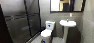 a bathroom with a toilet and a sink at Natural Manzanillo in Manzanillo